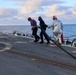 GSM2 Mark Bacca and DC3 Asia Taylor transport the fueling hose to a MH-60R Sea Hawk helicopter to re-fuel