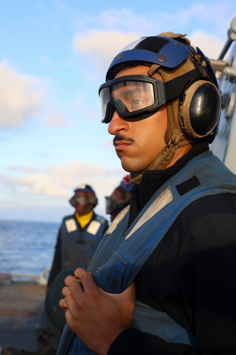 BM1 Youssef Belakbir observes helicopter operations on the flight deck of the Bulkeley