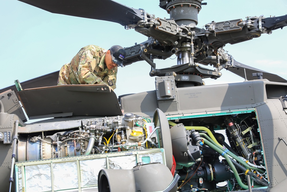 12th CAB conduct preventative maintenance checks and services on AH-64 Apache Attack Helicopter during Saber Guardian 25