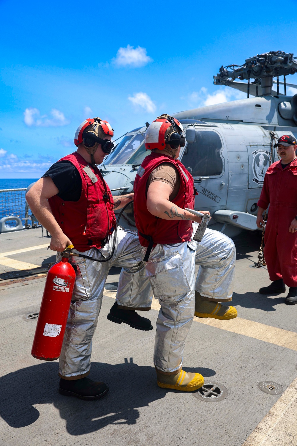 DC3 Levi Nuslein and DC2 Asia Taylor use a fire extinguisher to respond to a simulated fire