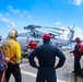 U.S. Navy Sailors man firehoses to respond to a simulated fire