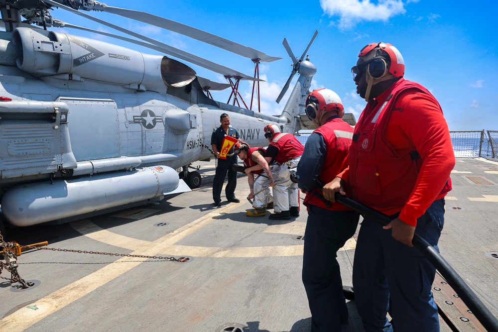 U.S. Navy Sailors respond to a simulated fire on the USS Bulkeley