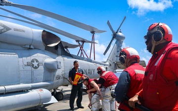 U.S. Navy Sailors respond to a simulated fire on the USS Bulkeley