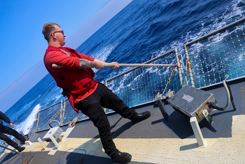 DC3 Evan Mcdonald releases the side nets prior to flight operations