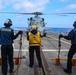 BM2 Jalynn Simmons, BM3 Sanaa Cooks and BM1 Jason Carpenter signal to MH-60R Sea Hawk helicopter pilots