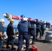 U.S. Navy Sailors bring the jack staff onto the foc’sle