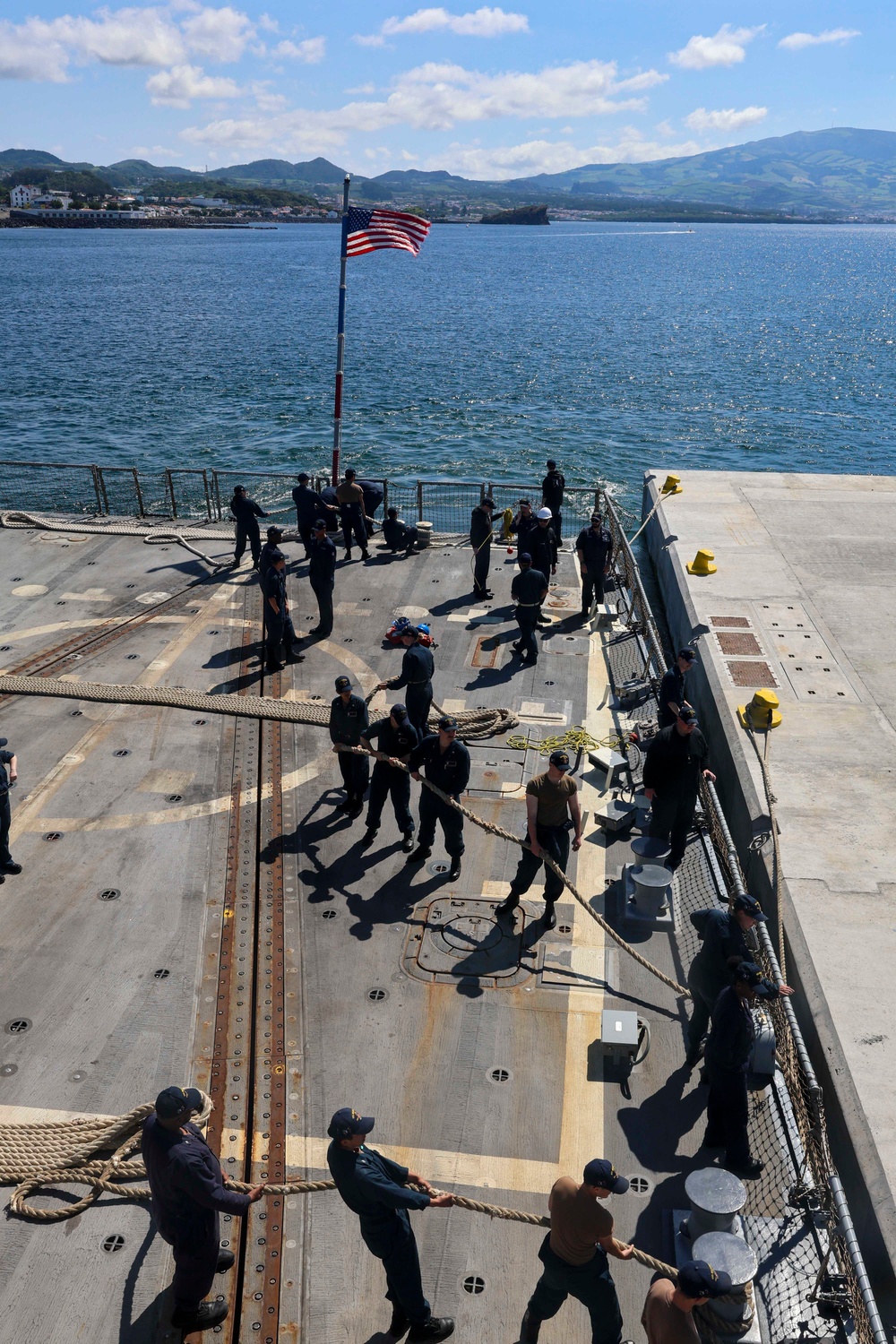 U.S. Navy Sailors pull in all mooring lines during a sea-and-anchor evolution