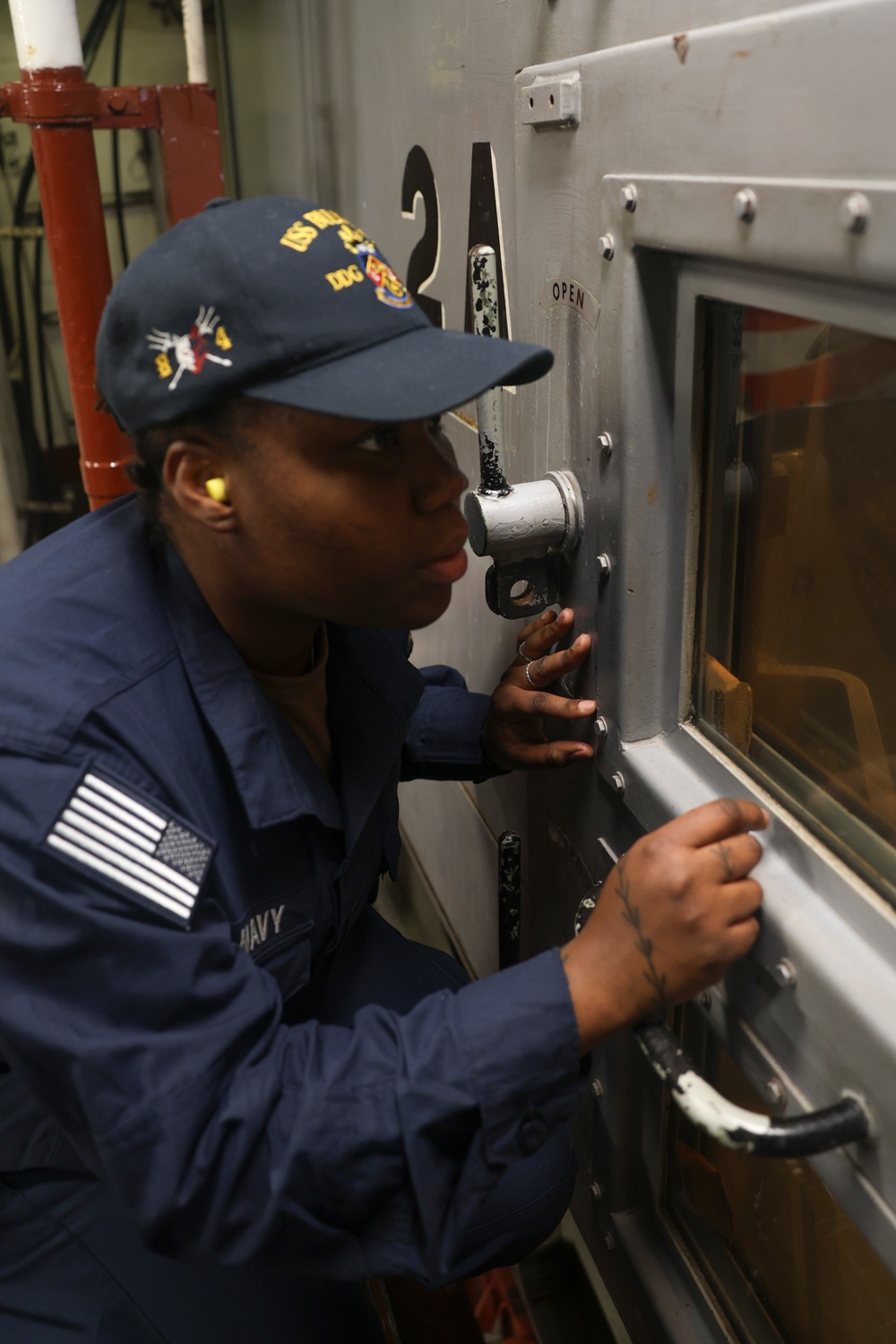 GSM Tawayna Brown conducts a visual inspection of an engine compartment