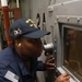 GSM Tawayna Brown conducts a visual inspection of an engine compartment