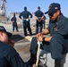 BM3 Collin Garey and BM3 Evandare Aganon splice an eye (loop) into a line while approaching pier side Naval Station Rota
