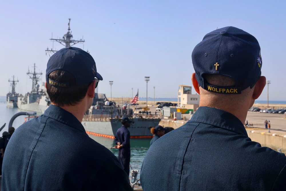 LTJG Brandon Sleik and Chaplain Joshua Keatts man the rails and observe the ship approaching pier side Naval Station Rota