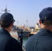 LTJG Brandon Sleik and Chaplain Joshua Keatts man the rails and observe the ship approaching pier side Naval Station Rota