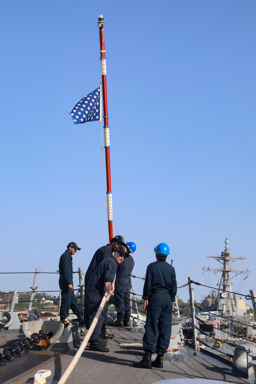 U.S. Navy Sailors raise the U.S. Union Jack flag during sea-and-anchor