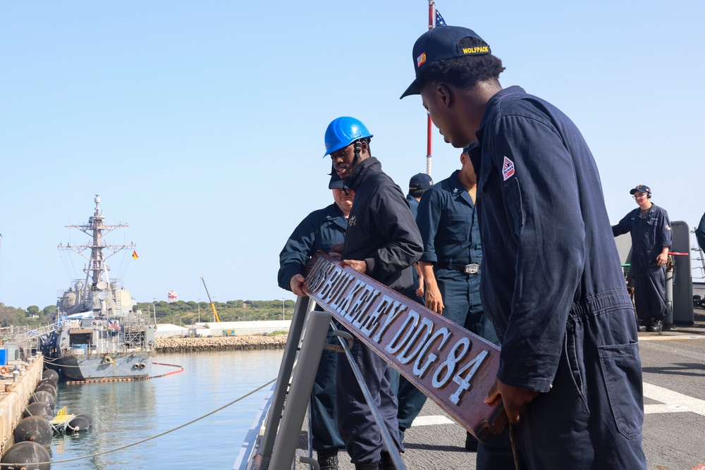 BM3 Carlens Milice and BMSA Dewan Henry attach the ships name placard to the lifeline during sea-and-anchor