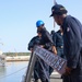 BM3 Carlens Milice and BMSA Dewan Henry attach the ships name placard to the lifeline during sea-and-anchor