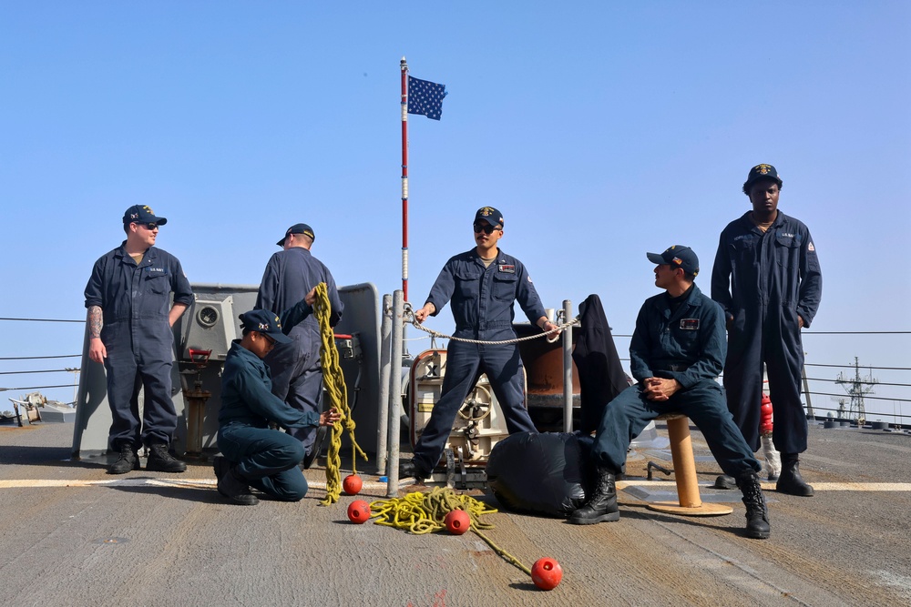 Wolfpack Sailors stow heaving lines after completing a sea-and-anchor evolution