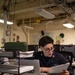 Nimitz Sailor Reads Through Paperwork