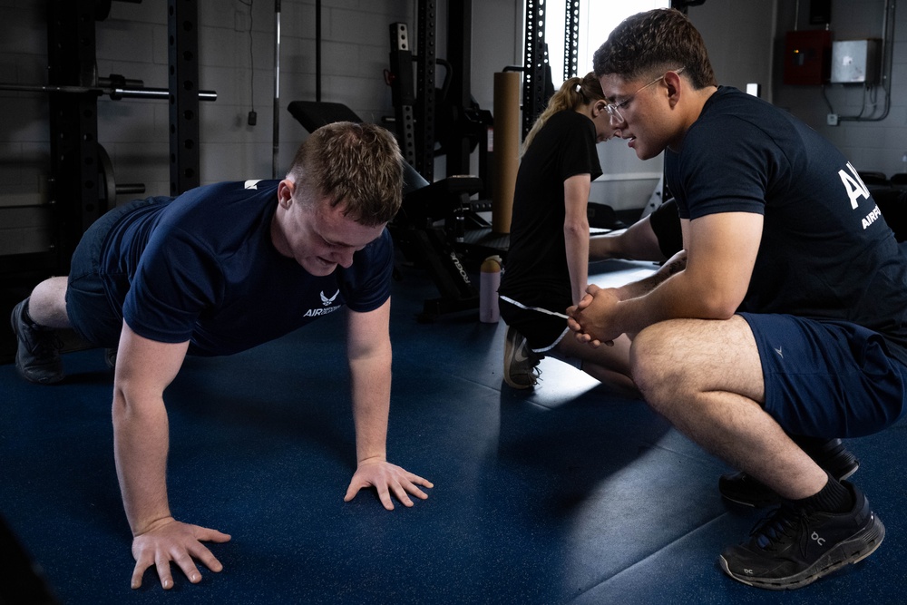 Student flight Airman participate in a mock Air Force Physical Fitness Assessment