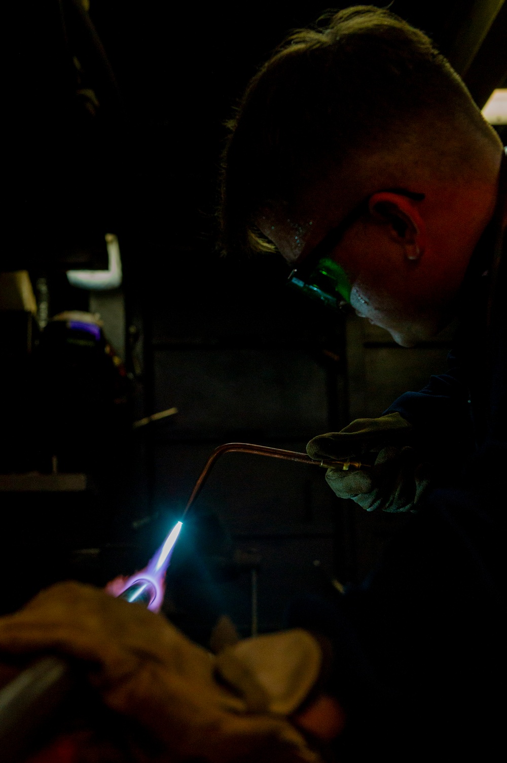 Hull Maintenance Technician anneals a carbon steel pipe while underway in the Pacific Ocean