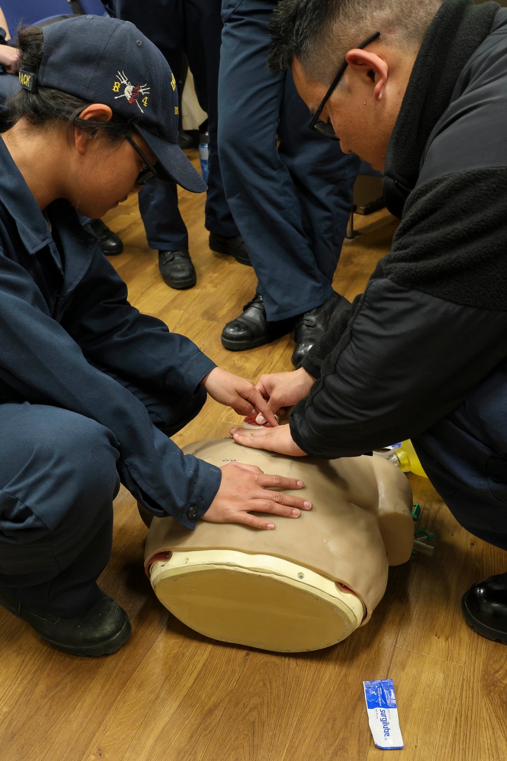 SA Terriejanniene NG and HM3 Timothy Efendy conduct Tactical Combat Casualty Care training
