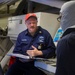 EM1 Kevin Parker conducts a damage control training debrief with crew members