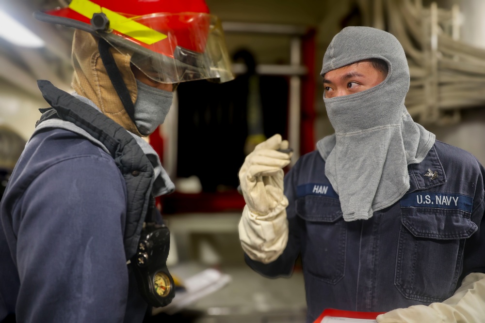 DC3 Michael Manio and GSM2  Chris Han review their plan of attack during a damage control general quarters