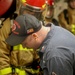 DC1 Cody Dormandy demonstrates the proper use of a firehose during a damage control general quarters