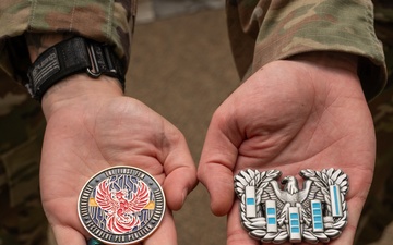U.S. Air Force Chief Warrant Officers 2 Brian Mundorff and Jonathan DeRivera display new challenge coins