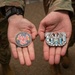 U.S. Air Force Chief Warrant Officers 2 Brian Mundorff and Jonathan DeRivera display new challenge coins