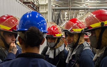 Sailors participate in a general quarters drill aboard USS Ronald Reagan (CVN 76)