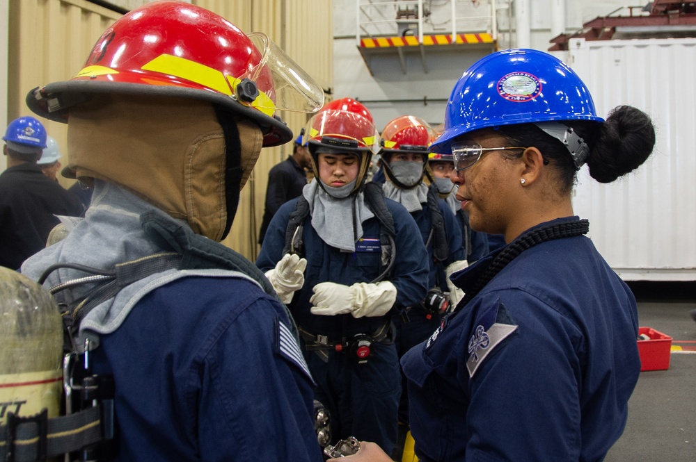 Sailors participate in a general quarters drill aboard USS Ronald Reagan (CVN 76)