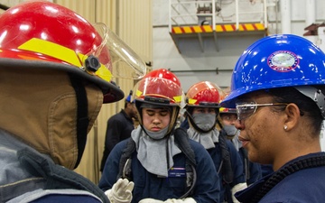 Sailors participate in a general quarters drill aboard USS Ronald Reagan (CVN 76)