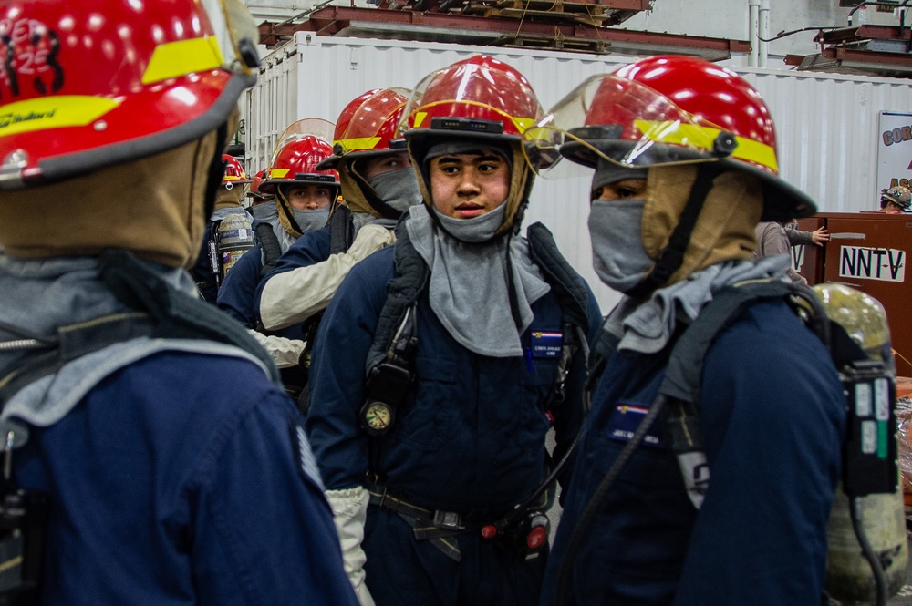 Sailors participate in a general quarters drill aboard USS Ronald Reagan (CVN 76)