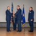 Lt. Col. Matthew Daniels, outgoing 377th Comptroller Squadron commander, passes the unit guidon to Col. Michael Power, 377th Air Base Wing and installation commander, during the 377th CPTS change of command ceremony