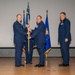 Lt. Col. James Denny, incoming 377th Comptroller Squadron commander, receives the unit guidon from Col. Michael Power, 377th Air Base Wing and installation commander
