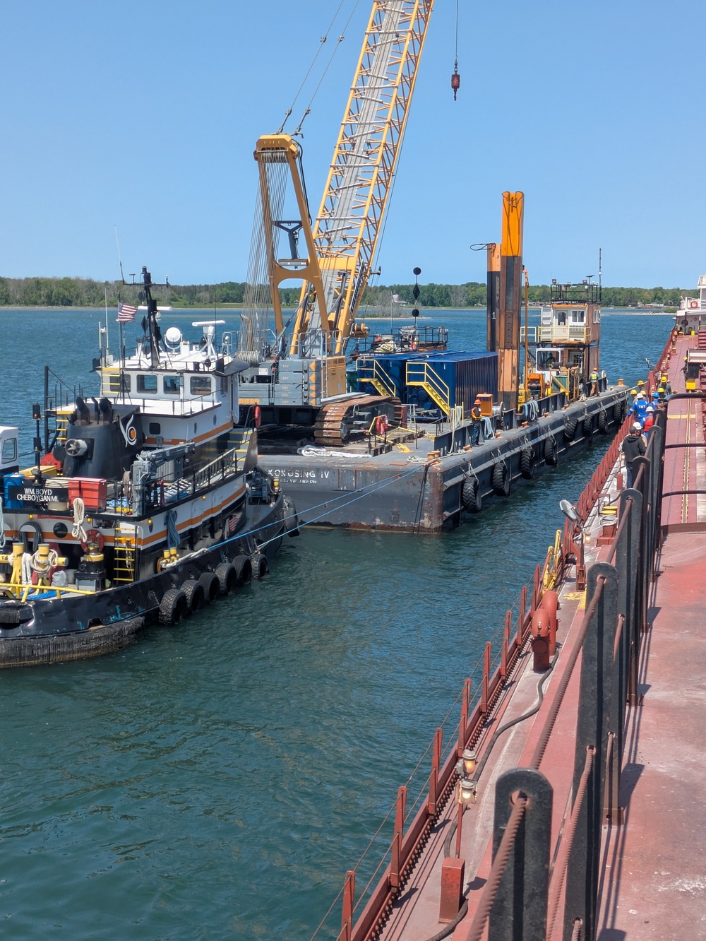 Hay Lake Marine Casualty responders move a barge with containment tanks into position