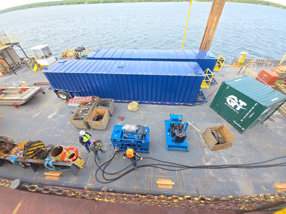 Hay Lake Marine Casualty responders prepare containment tanks aboard a work barge