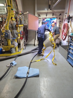 Hay Lake Marine Casualty responders aboard the M/V Hon. James L. Oberstar prepare to transfer fuel