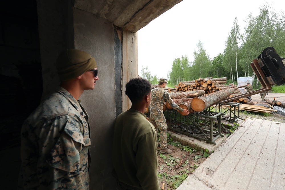 Marines and Latvian Engineers Cut Lumber for Trench Support - BALTOPS 25