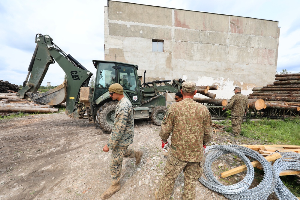 Marines and Latvian Engineers Cut Lumber for Trench Support - BALTOPS 25