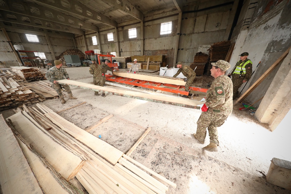 Marines and Latvian Engineers Cut Lumber for Trench Support - BALTOPS 25