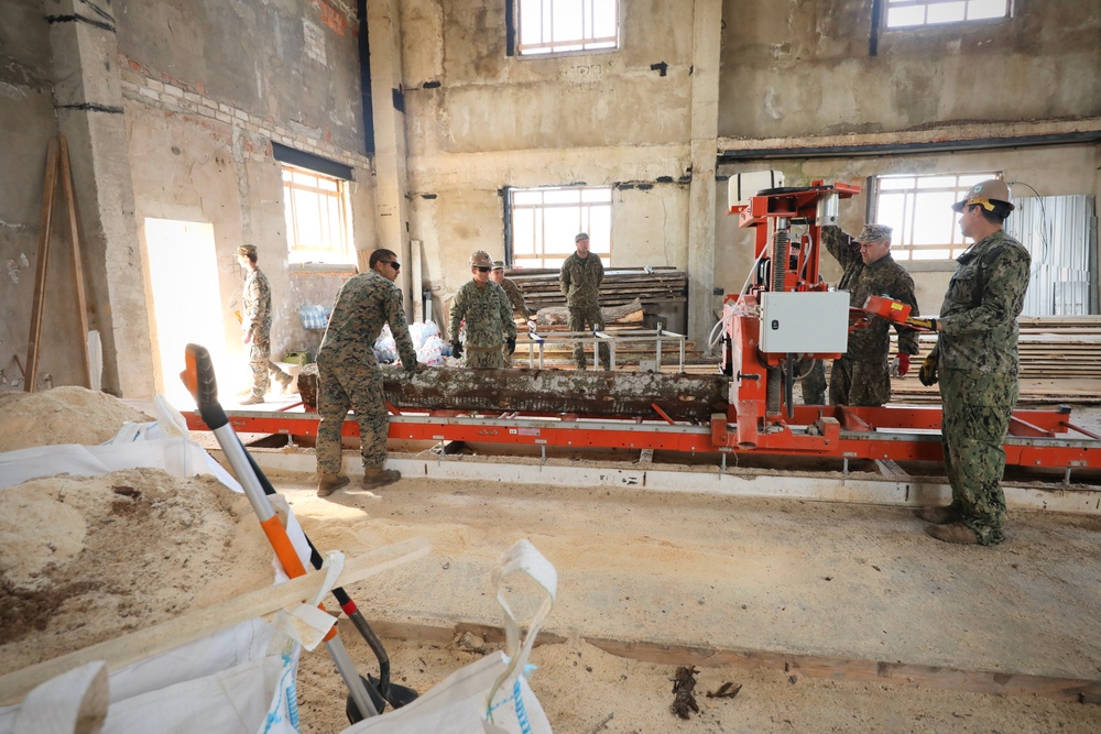 Marines and Latvian Engineers Cut Lumber for Trench Support - BALTOPS 25