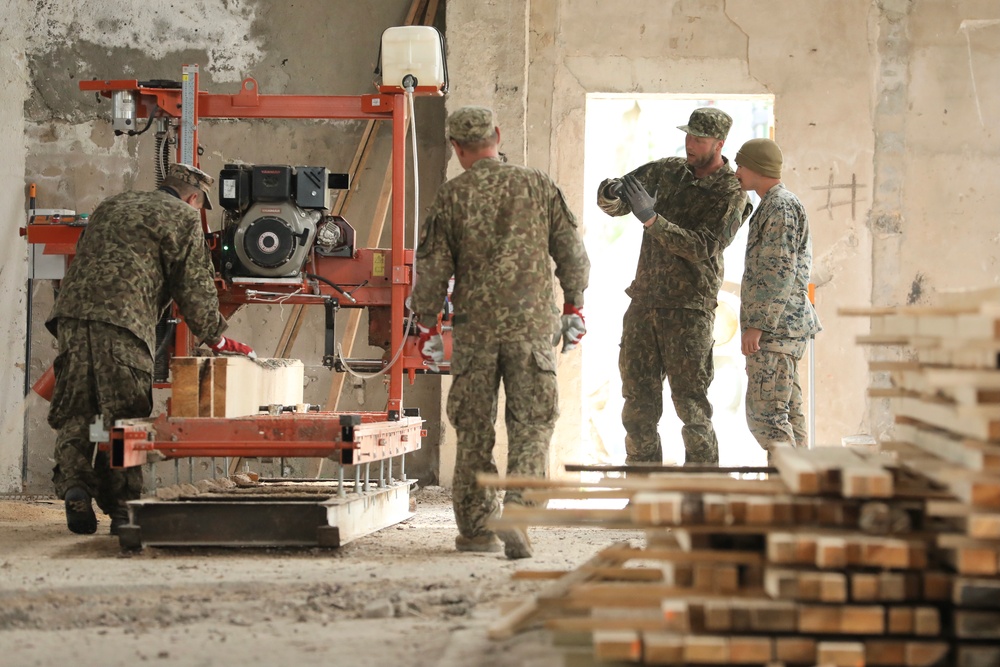 Marines and Latvian Engineers Cut Lumber for Trench Support - BALTOPS 25