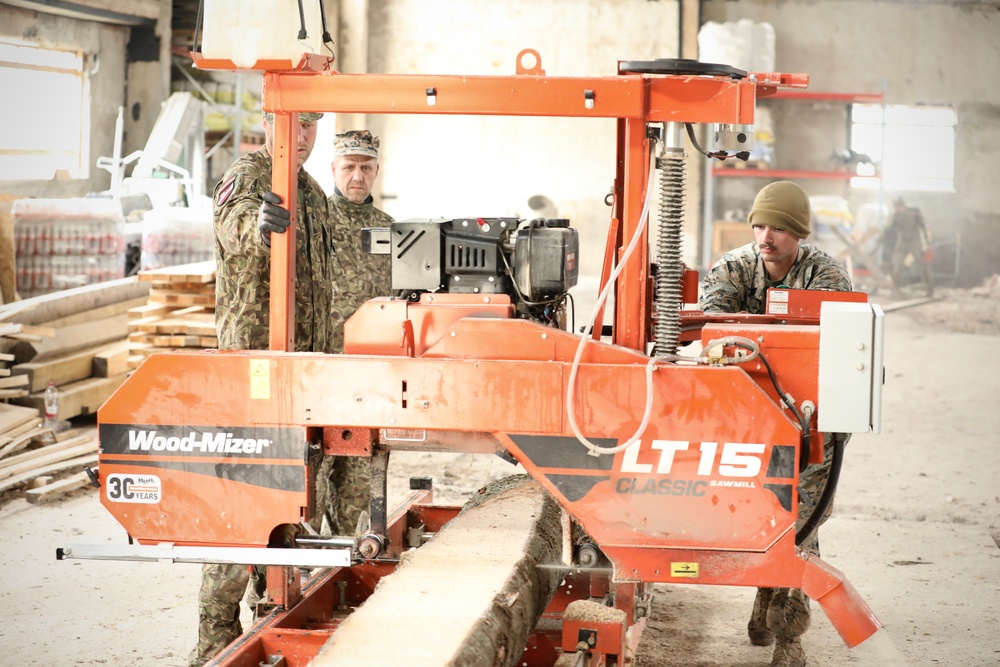 Marines and Latvian Engineers Cut Lumber for Trench Support - BALTOPS 25