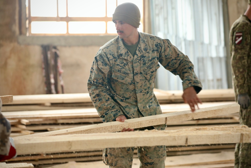 Marines and Latvian Engineers Cut Lumber for Trench Support - BALTOPS 25