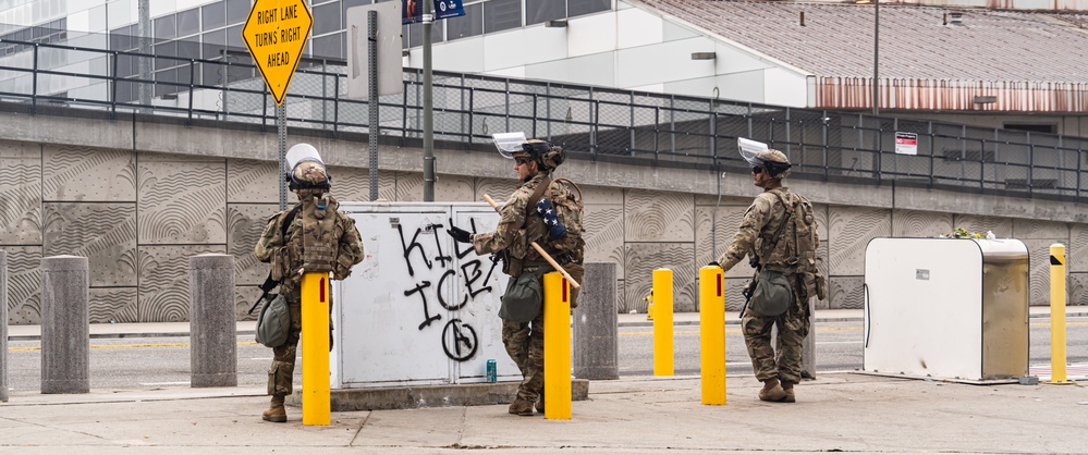 Soldiers of the 1st Battalion, 185th Infantry Regiment provide protection to a federal building