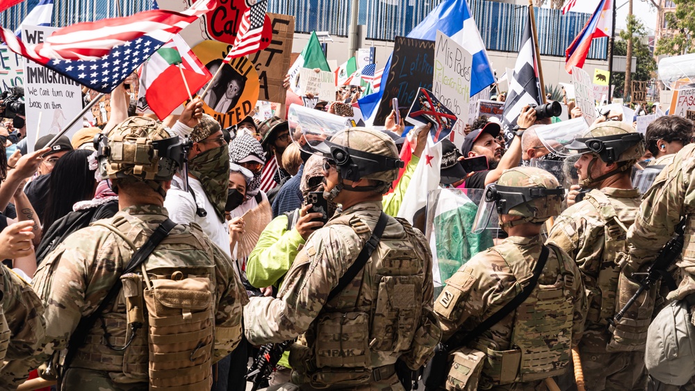 U.S. Army Soldiers and U.S. Marines provide protection to a federal building