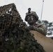 Iowa National Guard Soldier pulling security in camouflage at JRTC