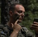 Kosovo Security Force soldier applies face paint during training at JRTC