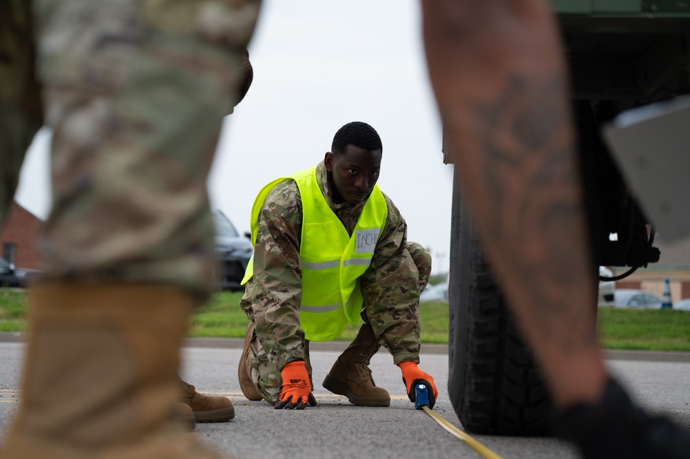 Cardinal Strike participant measures the length of a Humvee